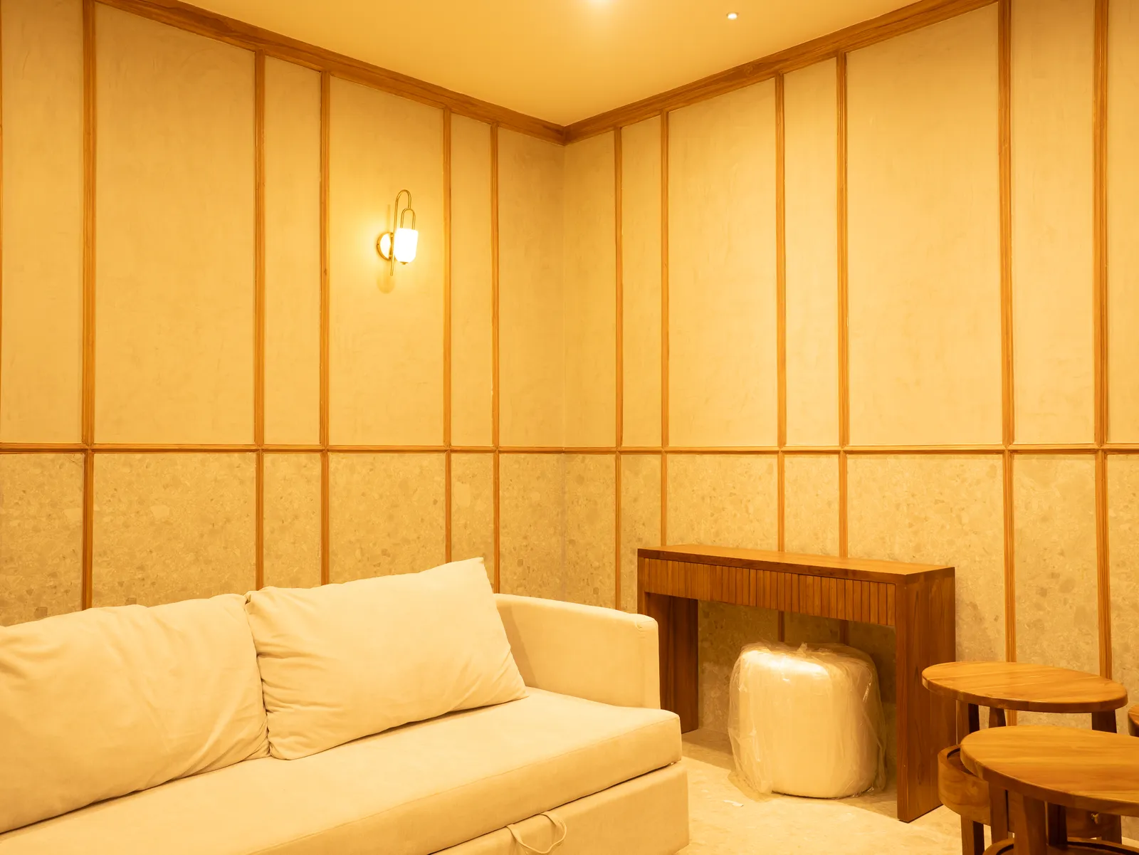 Waiting lounge with cream sofa and panelled walls — Chalukya Samrat